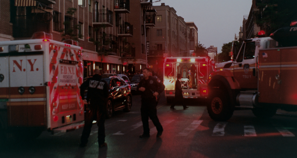 Firefighters, paramedics and police at an emergency scene at dusk