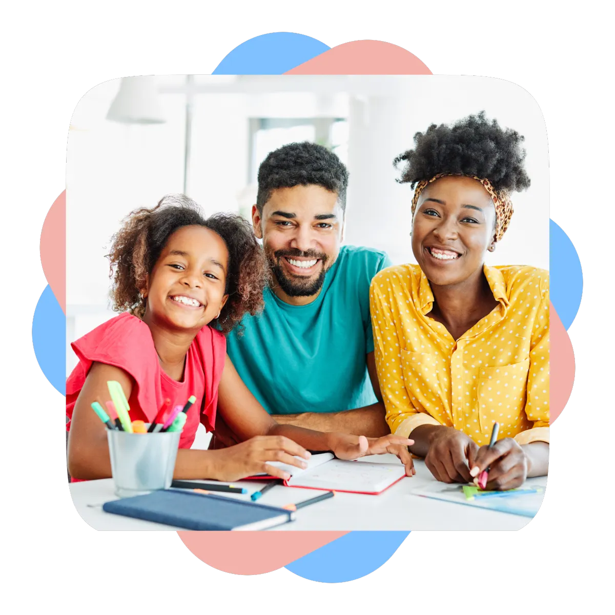 Smiling parents and their daughter doing schoolwork together at a table